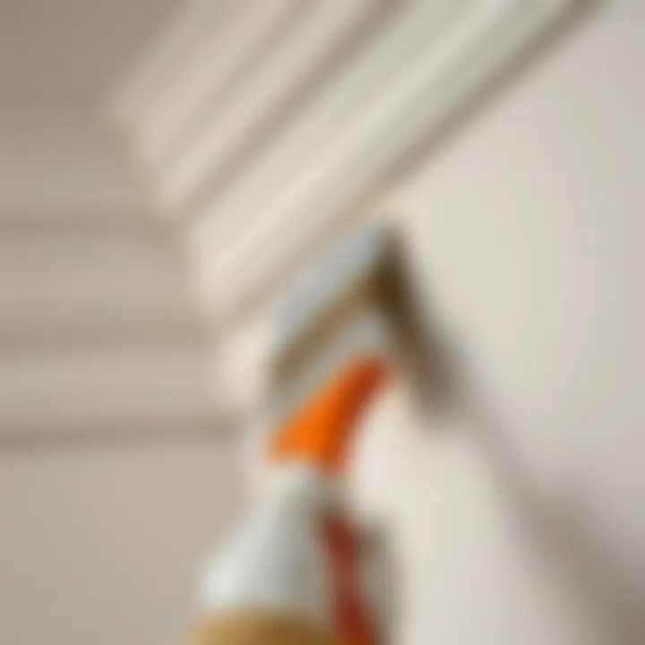 Detailed view of a painter applying texture to cornice with a brush