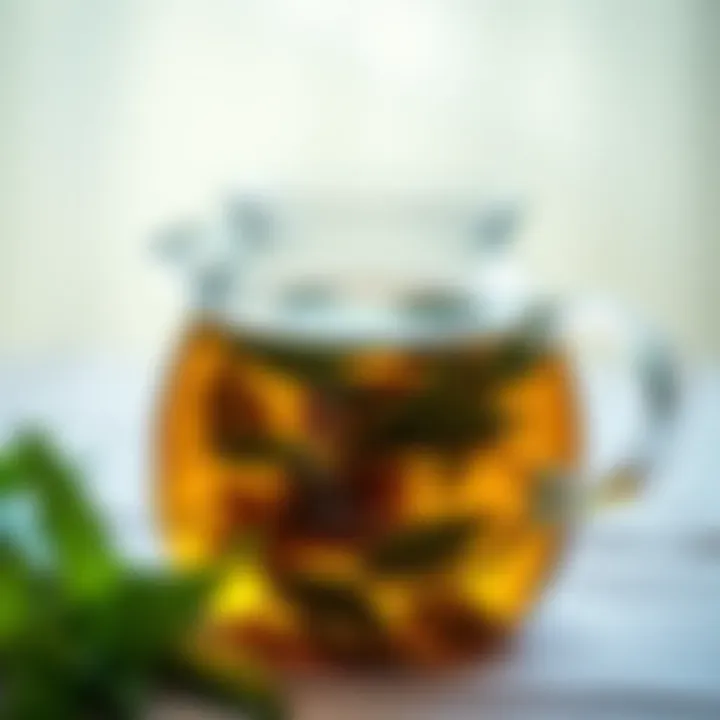 Tea leaves steeping in a clear glass teapot